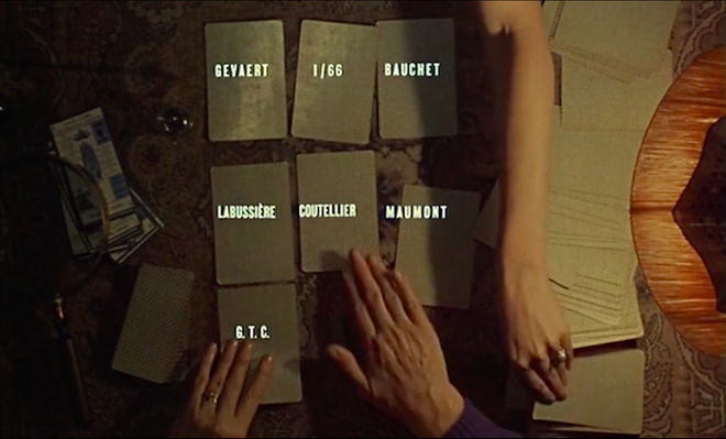IMAGE: Still - 03 Two hands dealing cards with credits